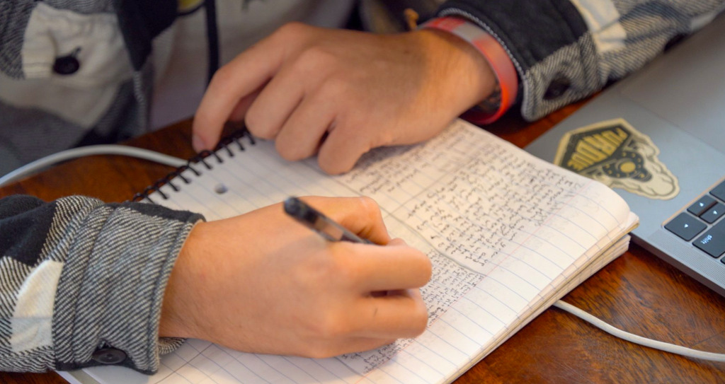person writing in journal - sober living in New Jersey