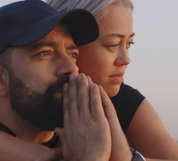 man and woman sitting together - recovery support group concept
