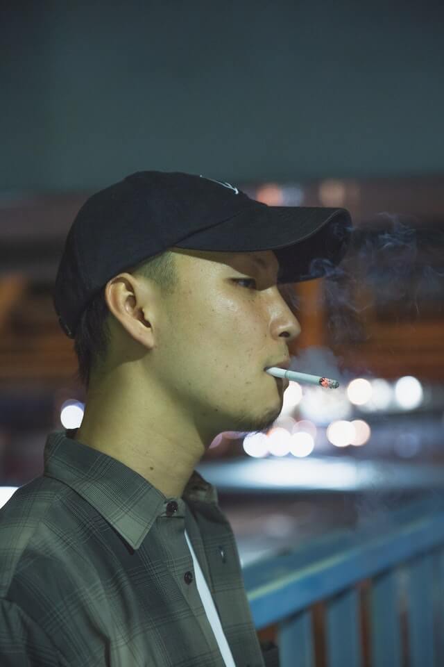 Young man smoking cigarette